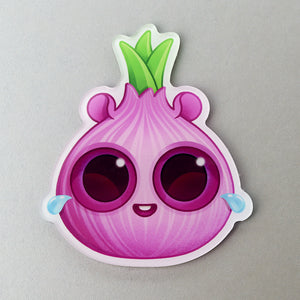 A cute, cartoon-style "Crybaby Onion" Acrylic Magnet from Bindlewood Shop with big sparkly eyes and a cheerful smile.