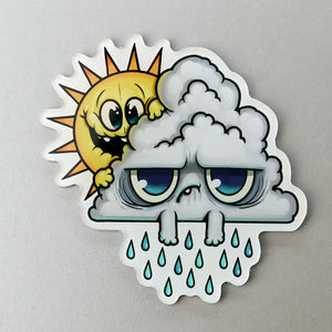 A sticker featuring an anthropomorphized sun and cloud: the sun from the "Rainy Day Friends" Acrylic Magnet, designed by Chris Ryniak, appears mischievous while peeking from behind the sad, crying cloud with droplets, from Bindlewood Shop.