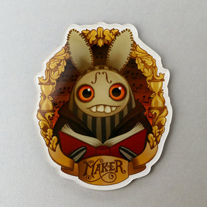 The Maker" Acrylic Magnet from Bindlewood Shop featuring a whimsically dark rabbit character dressed as a jester from Thimblestump Hollow, holding an open book, with musical notes and golden flourishes in the background.