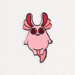 A whimsical Tiny Axolotl-bunny Pin featuring a creature with large ears, big round red eyes, and a small body, set against a plain white background by Bindlewood Shop.