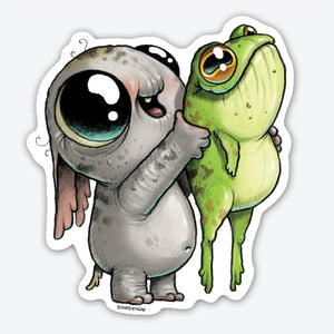 A whimsical vinyl sticker illustration of a grey, wide-eyed elephant-like creature touching noses affectionately with a green, big-eyed frog. Both characters have exaggerated, cartoonish features by Chris Ryni, featuring the Look What I Caught Sticker from Bindlewood Shop.