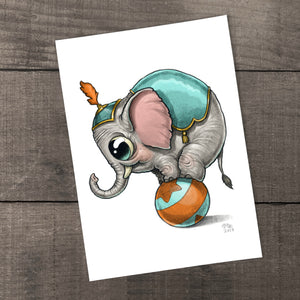 An adorable illustration of a baby elephant playfully balancing on a ball, wearing a cute circus hat, signed by the artist on archival fine art paper. ("Tiny Jumbo Print" by Chris Ryniak)