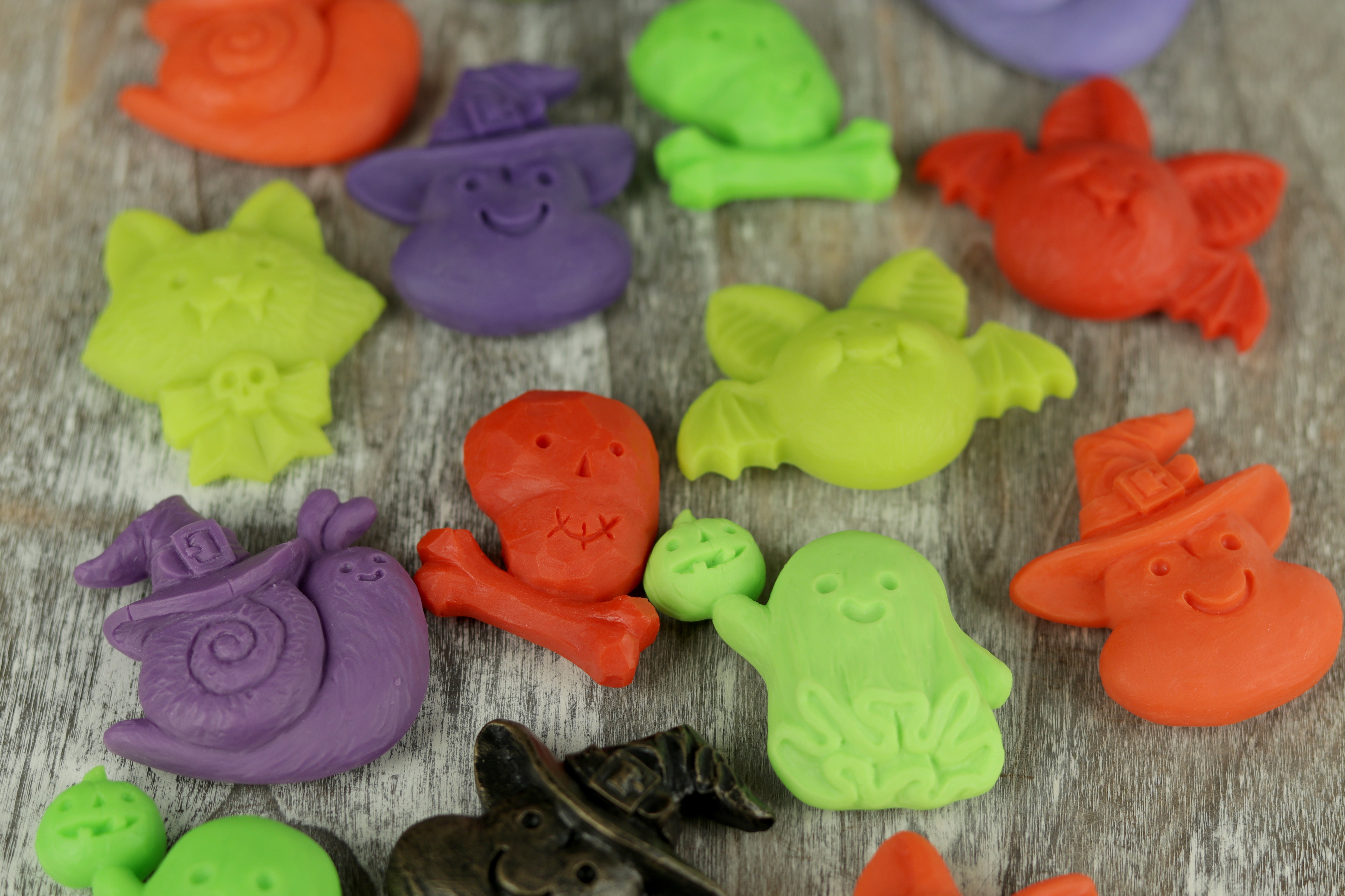 Colorful Halloween-themed clay figures on a wooden surface