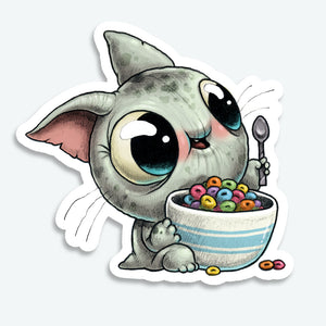 The Sugar Junk Sticker (3-inch) from Bindlewood Shop features a cute cartoon kitten with big eyes holding a spoon beside a bowl of sugar cereal, looking up eagerly—ideal as a vinyl sticker or durable decoration.
