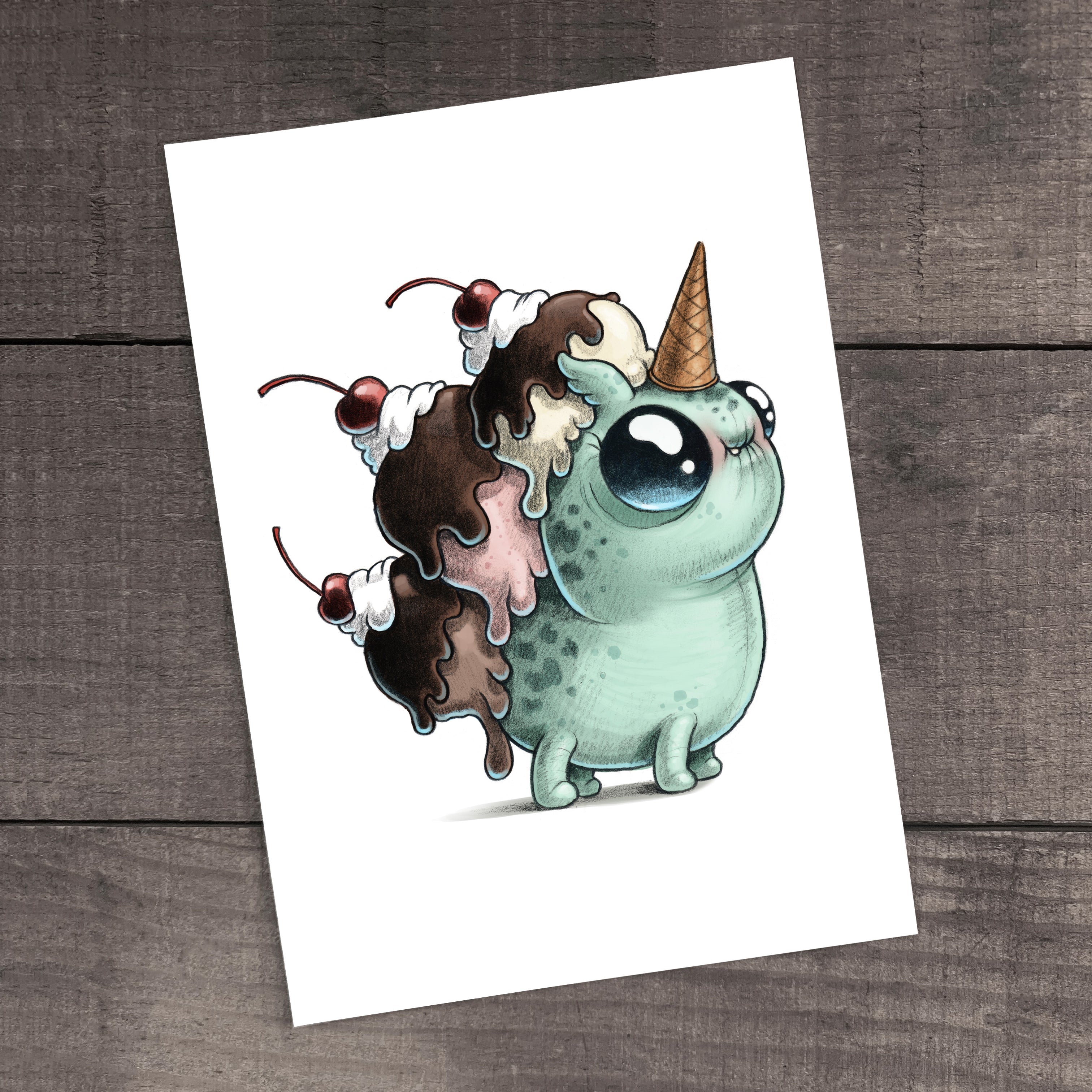 Wafflecorn Sundae" Print by Chris Ryniak: A mint-green cartoon creature with blue eyes, an ice cream cone horn, and scoops of ice cream with cherries on its back, shown as a fine art print on archival paper.