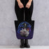 A person in black pants and boots holds the Mystical Witchbunny Tote by Bindlewood Shop, featuring a cute cat in a wizard hat with magical details—ideal for fans of Amanda Louise Spayd or the Witchbunny bag series.