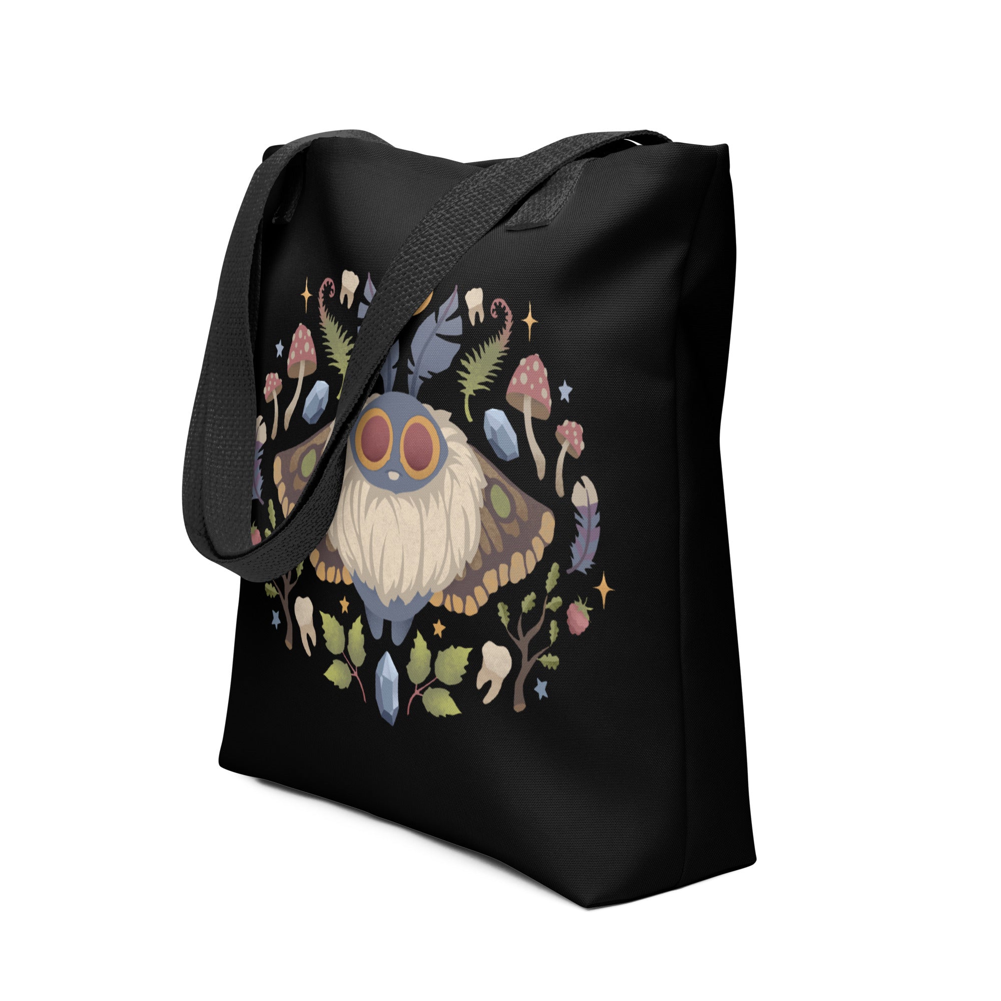 The Moth Magic Tote by Bindlewood Shop features a vibrant moth with red eyes, surrounded by plants, mushrooms, leaves, and flowers in a circular design, printed on weather-resistant fabric for durability.