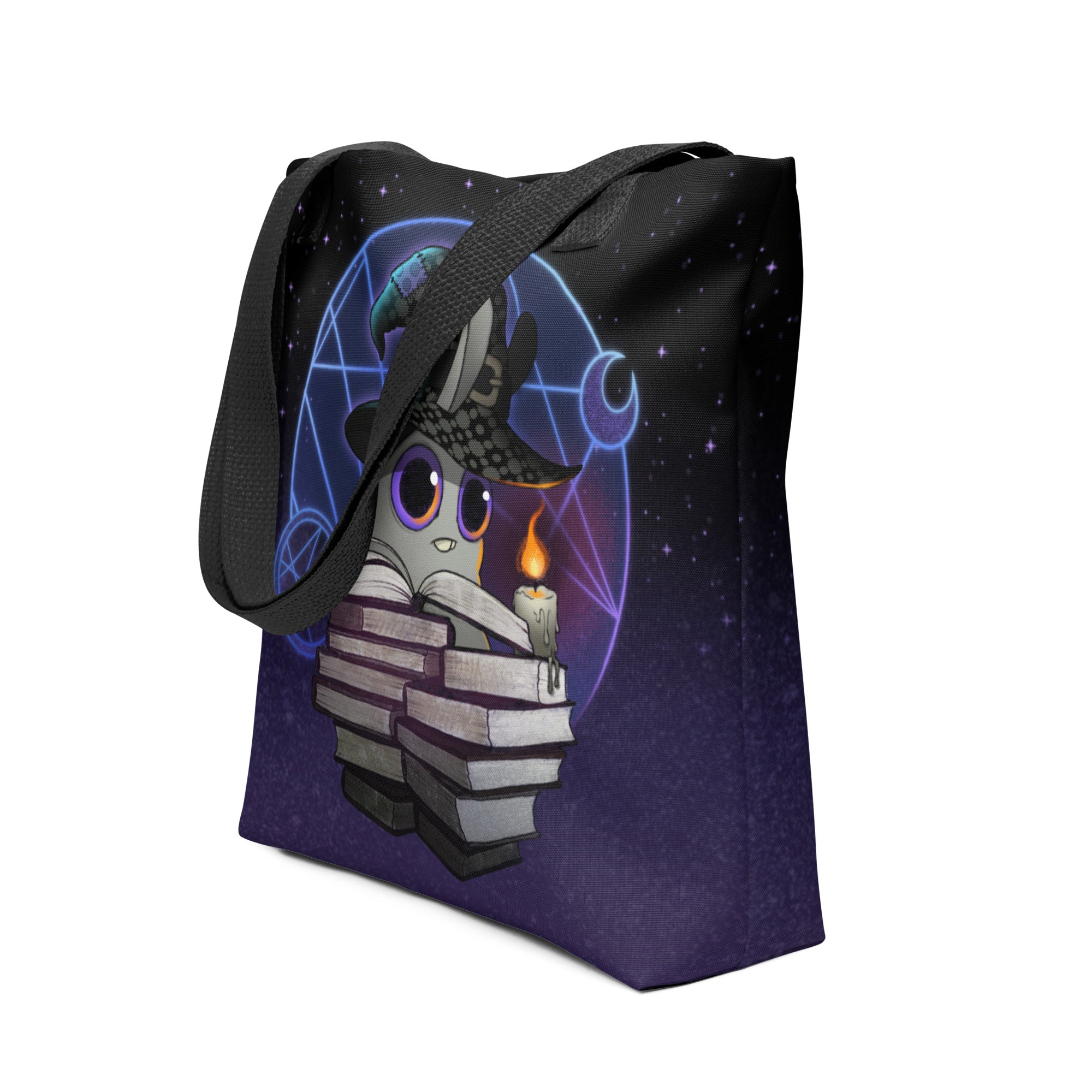 The Mystical Witchbunny Tote by Bindlewood Shop features a cute cartoon cat with books, a witch hat, and candle, surrounded by magical blue geometric designs—a perfect accessory for fans of Witchbunny bag magic.