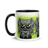 Introducing the Eyegurr Mug from Bindlewood Shop—a white ceramic mug with a black handle, showcasing a cartoonish three-eyed, owl-like creature with large green eyes against a vibrant, splattered green background. This unique collectible is perfect for fans of Chris Ryniak monster mugs and anyone who loves quirky drinkware.