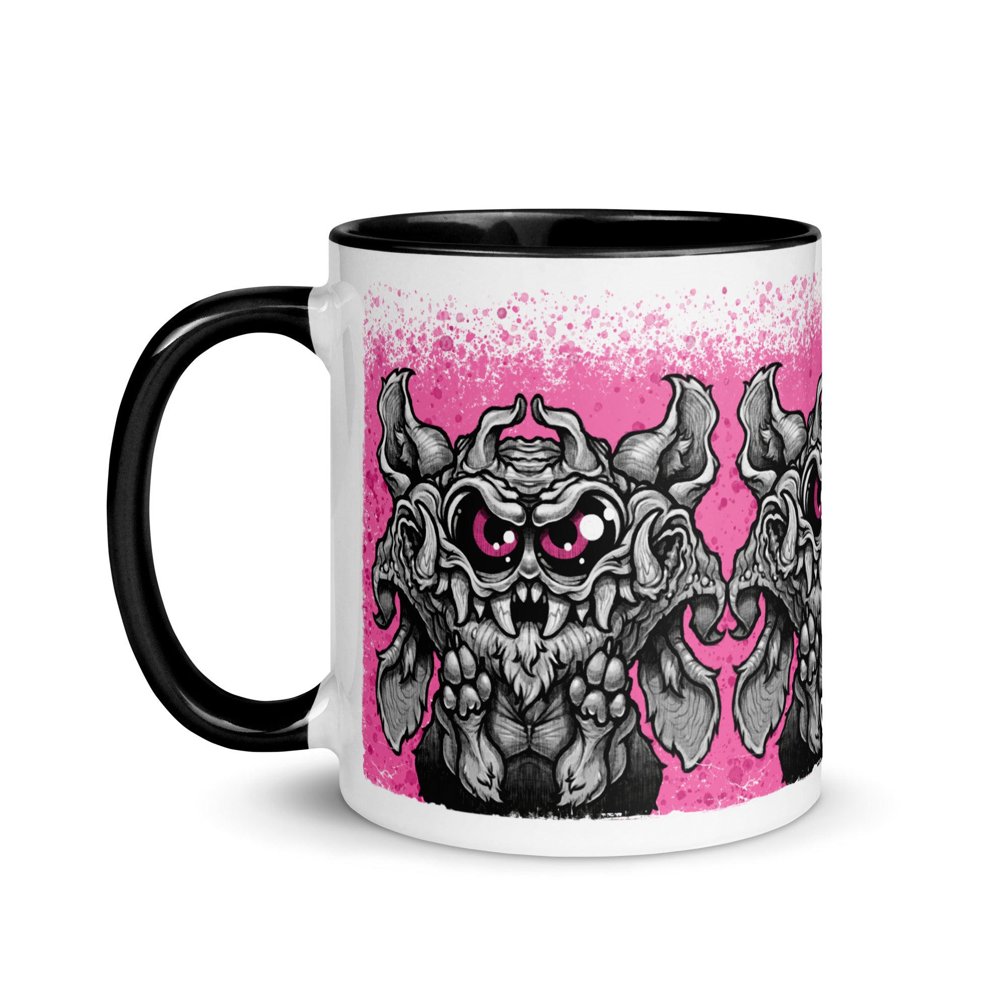 The Radbit Mug from Bindlewood Shop is a white ceramic mug with a black handle, showcasing a cartoonish gray bat-like monster with big pink eyes and fangs—evoking the style of a Chris Ryniak creation—set against a splattered pink background. This printed ceramic mug is perfect for fans of unique and whimsical designs.