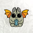 Illustration of a cute cartoon bat from Thimblestump Hollow with large eyes and orange wings, holding an Atticus Enamel Pin from Bindlewood Shop. The background is a crumpled white texture.