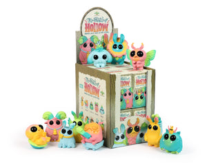 Nine whimsical creature figurines with big eyes surround a decorated box labeled “Thimblestump Hollow Series 2 - Single Blind Box” from Bindlewood Shop. This collectible mini-series features blind-boxed figures and charming matching illustrations.