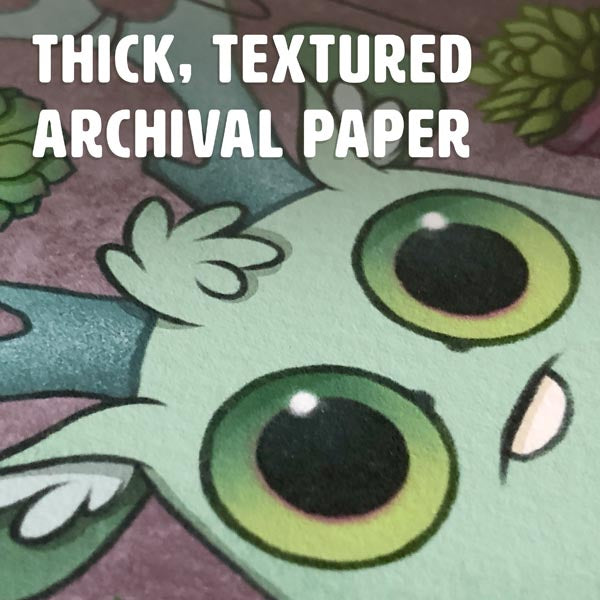 Close-up of Amanda L Spayd's Aries Zodiac Print, showing a vibrant creature with big green eyes on thick, textured archival paper. "Thick, Textured Archival Paper" is displayed at the top of the image.