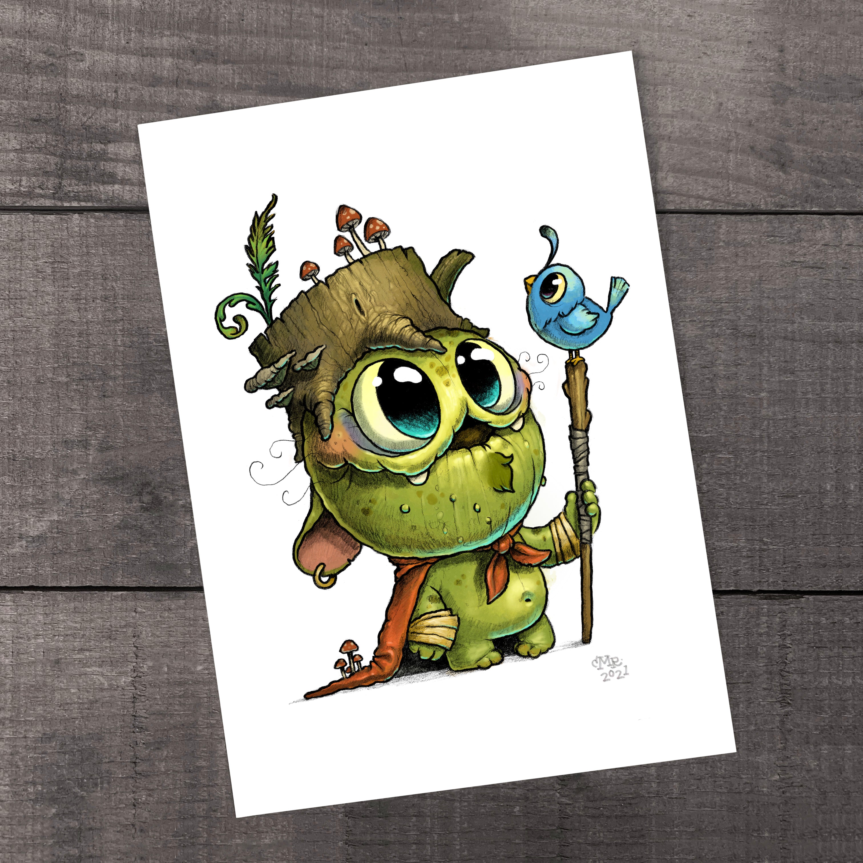 The "Wood Wizard" Print by Chris Ryniak features a whimsical green creature with a tree stump hat, red cape, and a blue-bird staff, standing on wood—perfect as a fine art print on archival art paper.
