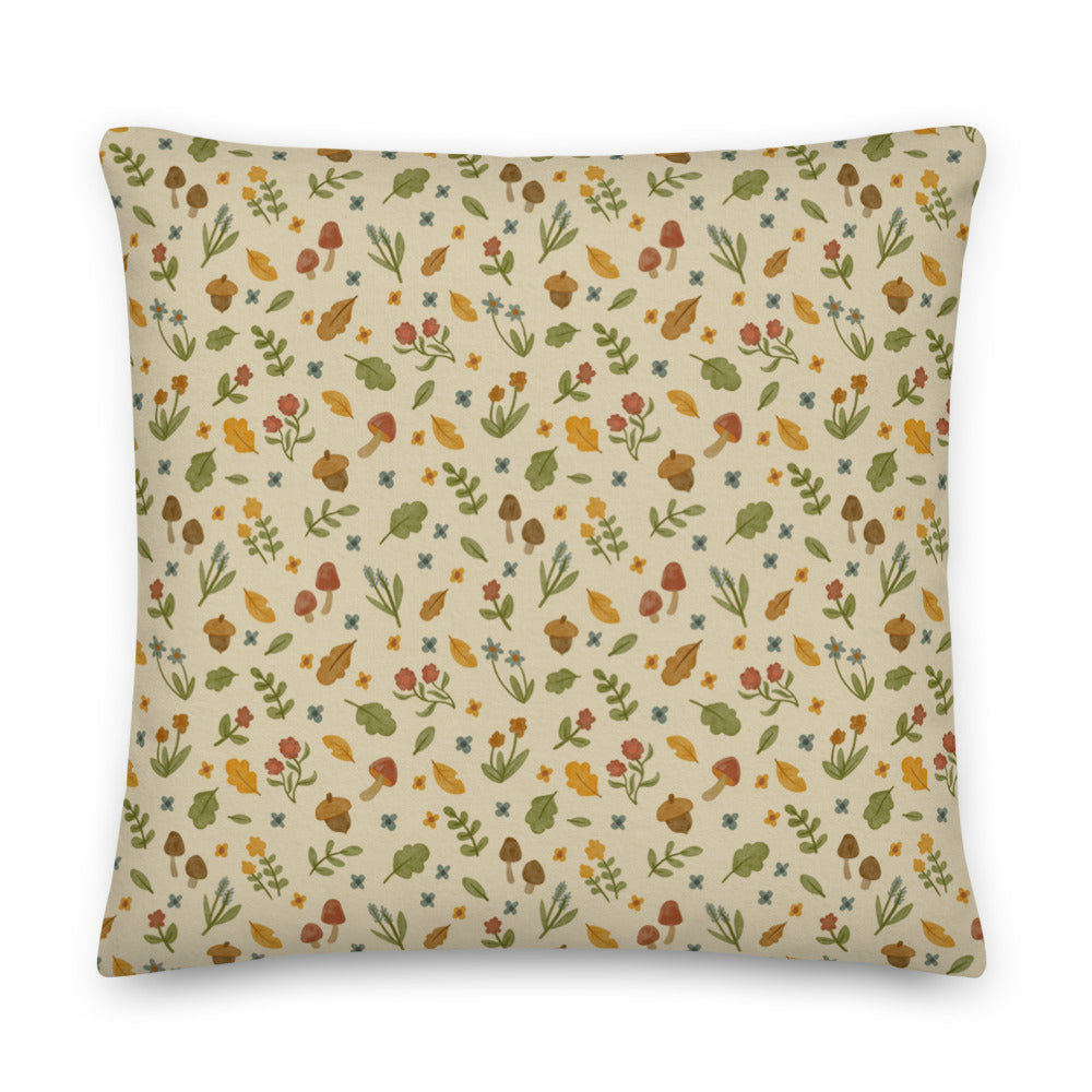 Introducing the Garden Sprite Throw Pillow by Bindlewood Shop—a rustic accessory featuring a beige background adorned with small, colorful illustrations of mushrooms, flowers, leaves, and acorns in earthy tones of green, brown, yellow, and orange. Perfect for adding a touch of cottagecore interior design to your home.