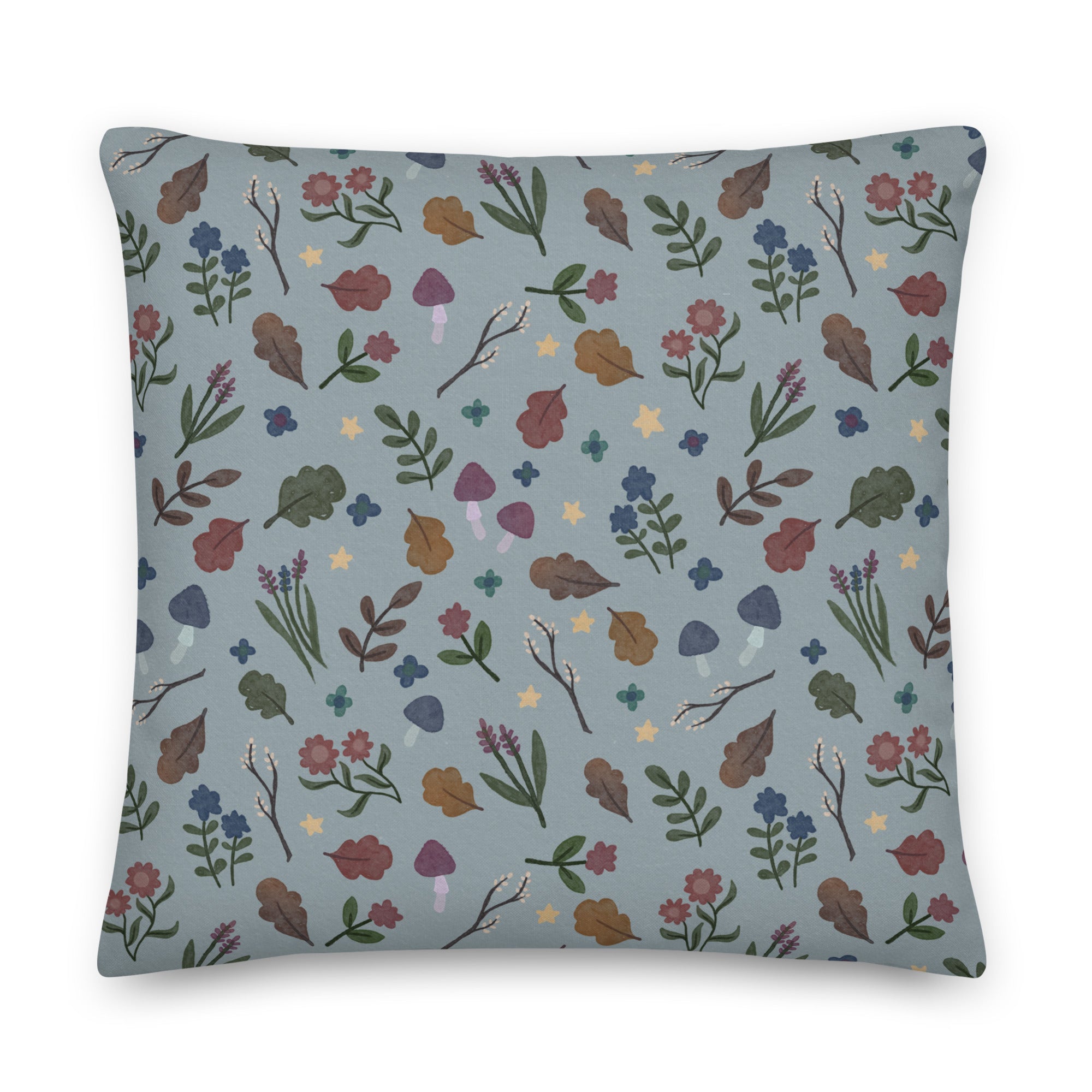 The Twilight Sprite Throw Pillow from Bindlewood Shop is a square rustic pillow featuring a pastel blue background adorned with an Amanda Louise Spayd illustration. The whimsical botanical pattern showcases various leaves, flowers, mushrooms, and stars in shades of green, purple, brown, and yellow—perfect for a cottagecore interior design.