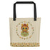Introducing the Garden Sprite Tote by Bindlewood Shop: a spacious cream-colored bag with black handles. It features a whimsical illustration of an animal-like character with large eyes, clad in a green outfit with a flower headpiece. The design is accentuated by a circular border of flowers and leaves, complemented by a floral pattern at the bottom and the signature Bindlewood logo in the corner.