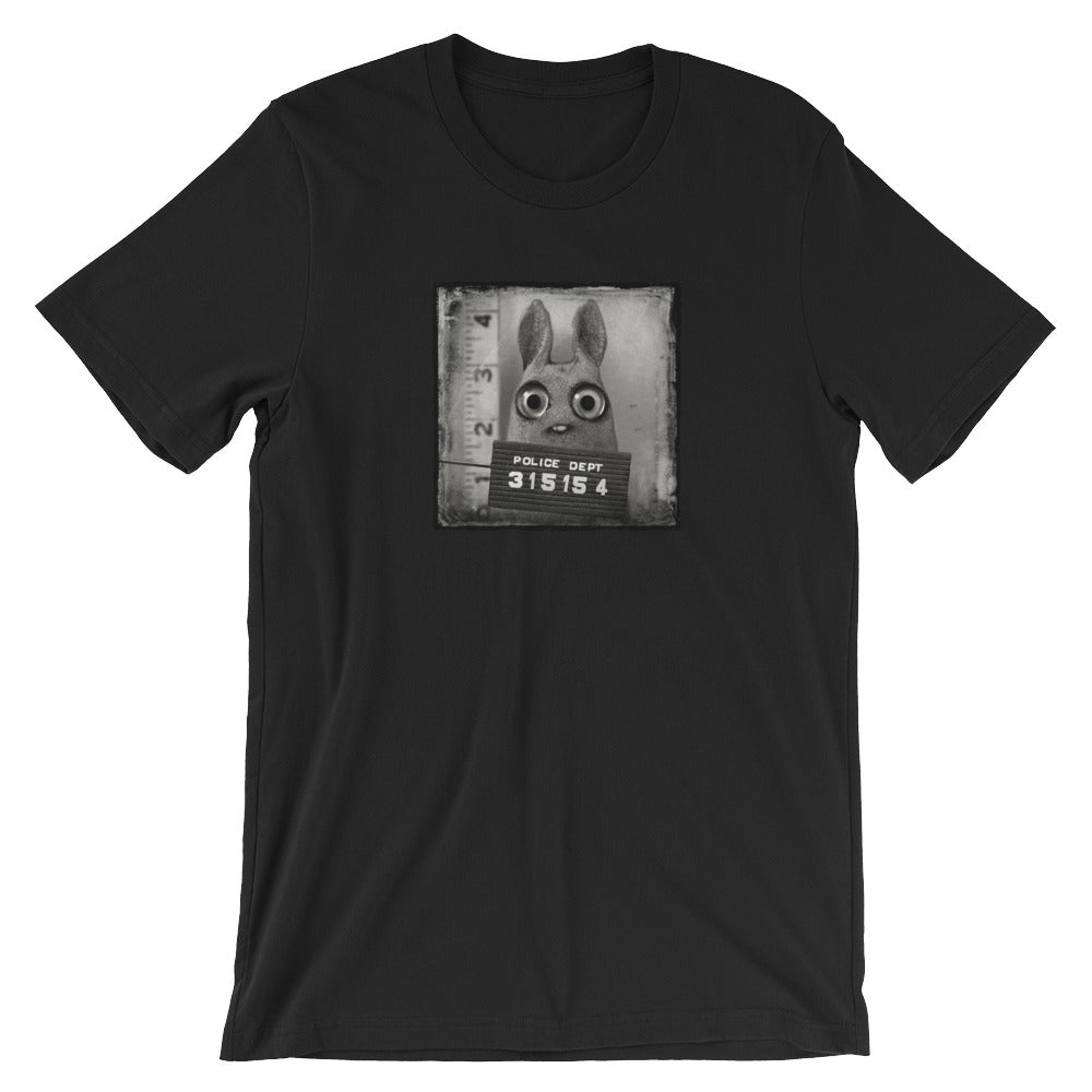The Pipsqueak Mugshot Tee by Bindlewood Shop features a black-and-white bunny mugshot with a "Police Dept 315154" sign, offering a stylish, vintage vibe and gender-neutral fit for all.
