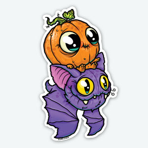 The Bindlewood Shop Pumpkin Bat Sticker (3-inch) features a cute cartoon pumpkin with big eyes sitting on a smiling purple bat. This playful vinyl sticker has bold outlines and a durable, matte finish—perfect for adding whimsy anywhere!.