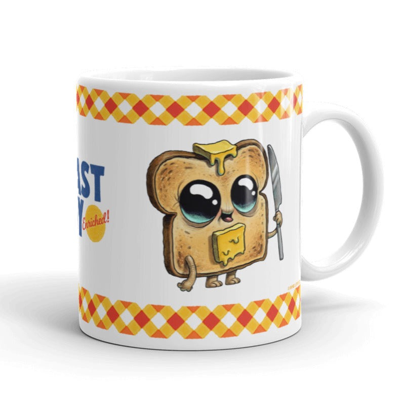 The Toastboy Mug from Bindlewood Shop is a glossy white ceramic mug showcasing an adorable cartoon toast character with big eyes and a pat of butter atop its head and body, clutching a butter knife. The handle is positioned on the right, while on the left side, there's a checkered border with partially visible text. Additionally, this mug is both dishwasher and microwave safe.
